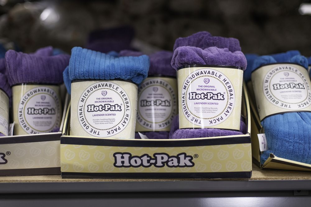 Lavender-scented microwavable herbal heat packs in purple and blue